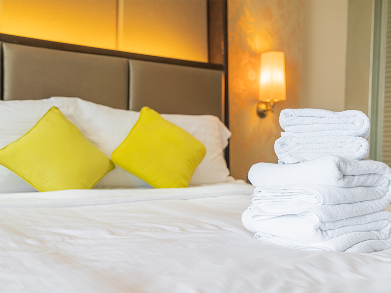 Elegant hotel bed with crisp white sheets and pillows